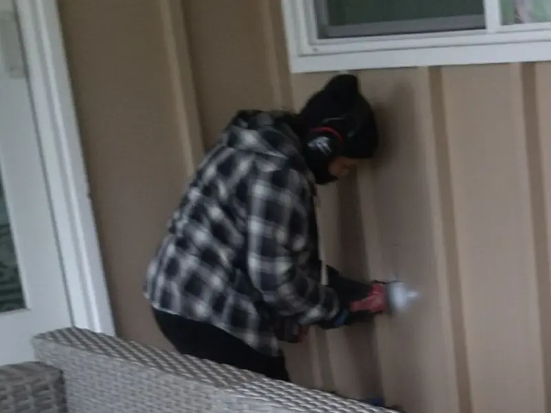 Professional electrician installing an exterior outlet in St. Paul