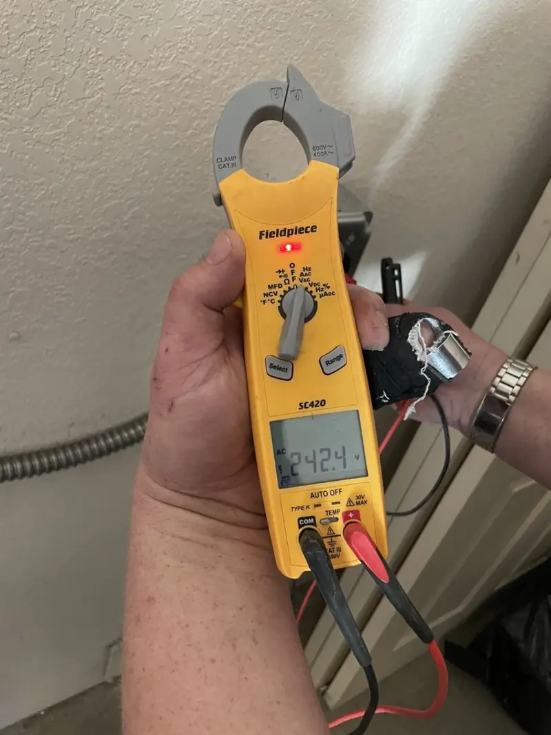 Voltage testing with clamp meter during Recessed Lighting Installation in St. Paul